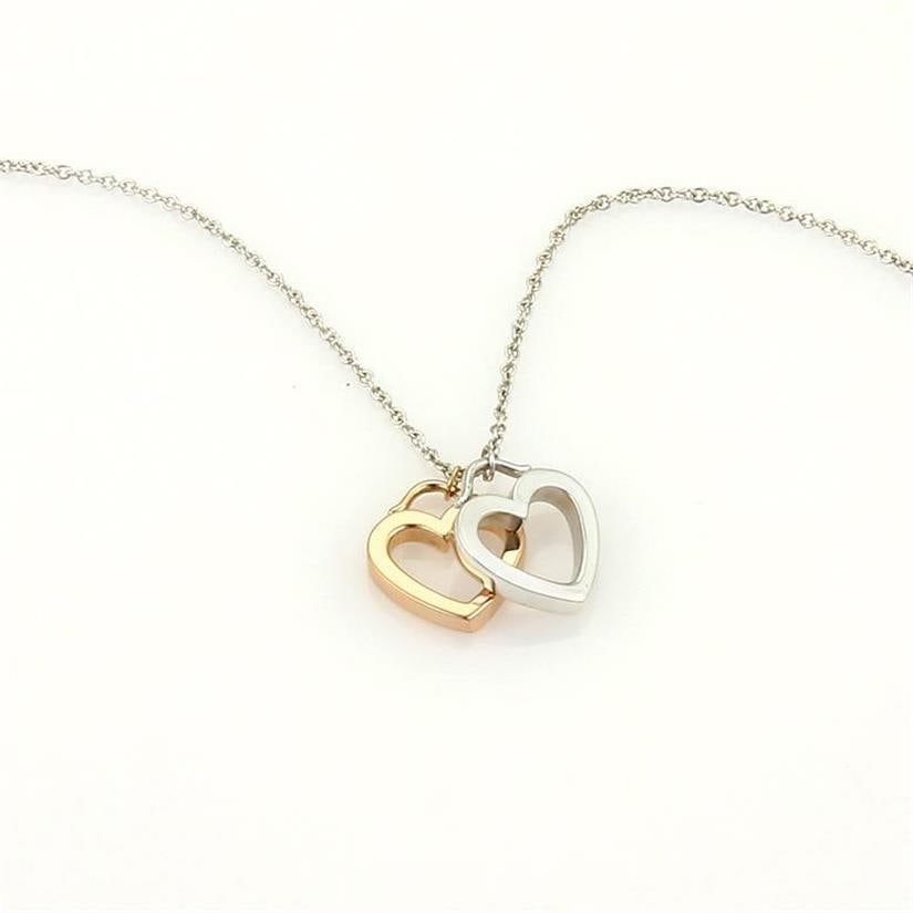 Tiffany & Co. Double Heart Pendant Sterling Silver 18k Gold with Chain: Tiffany & Co. Double Heart Pendant Sterling Silver 18k Gold with Chain This exquisite Tiffany & Co. Double Heart Pendant is a striking combination of sterling silver and 18k yellow gold. The piece fea