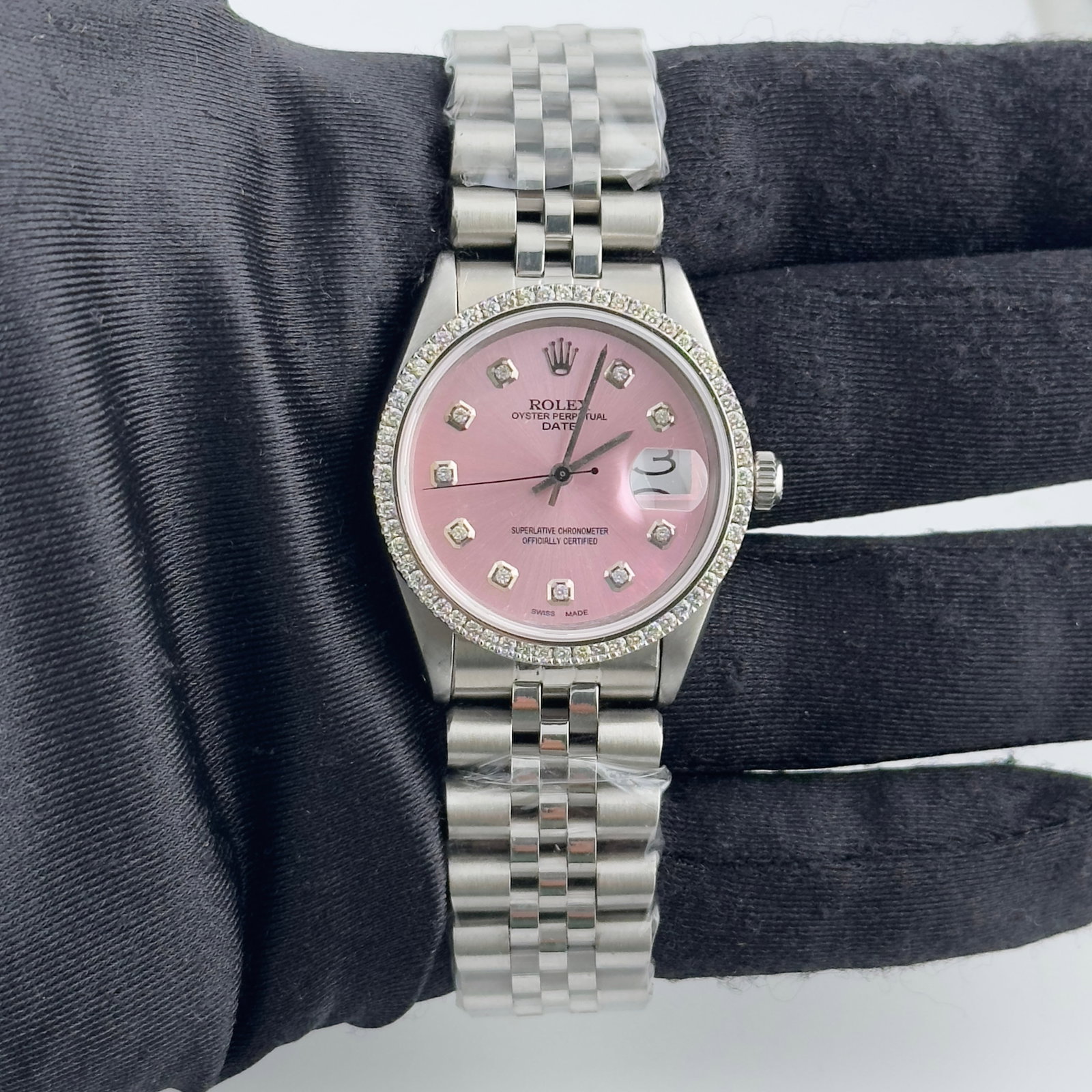 Rolex Date 6694 Pink Diamond Dial Aftermarket Jubilee Bracelet: Rolex Date 6694 Pink Diamond Dial Aftermarket Jubilee Bracelet This Rolex Date wristwatch features an aftermarket pink diamond dial and a prong-set diamond bezel, offering a distinctive and elegant ap