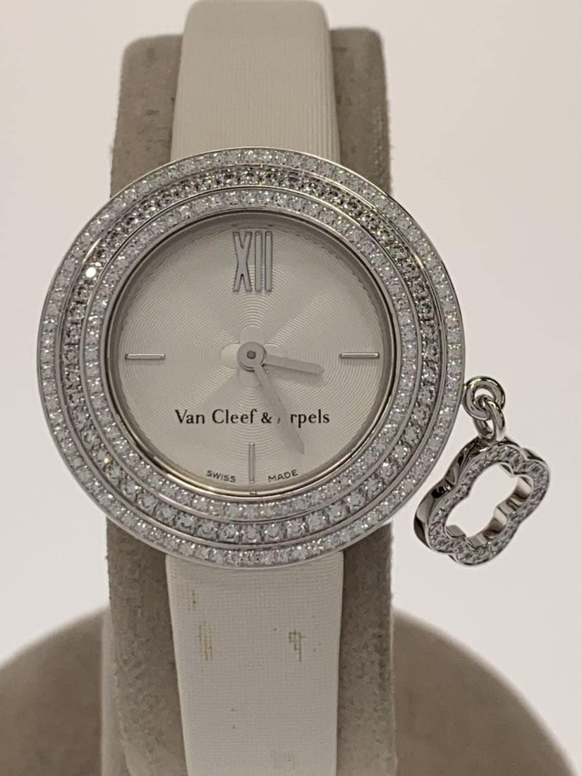 Van Cleef Arpels Mini Charm Silver Wristwatch: Van Cleef Arpels Mini Charm Silver Wristwatch This Van Cleef & Arpels Charm Watch Mini 3575164 is a women's wristwatch featuring a silver-tone case and band. The watch is pre-owned and shows slight si