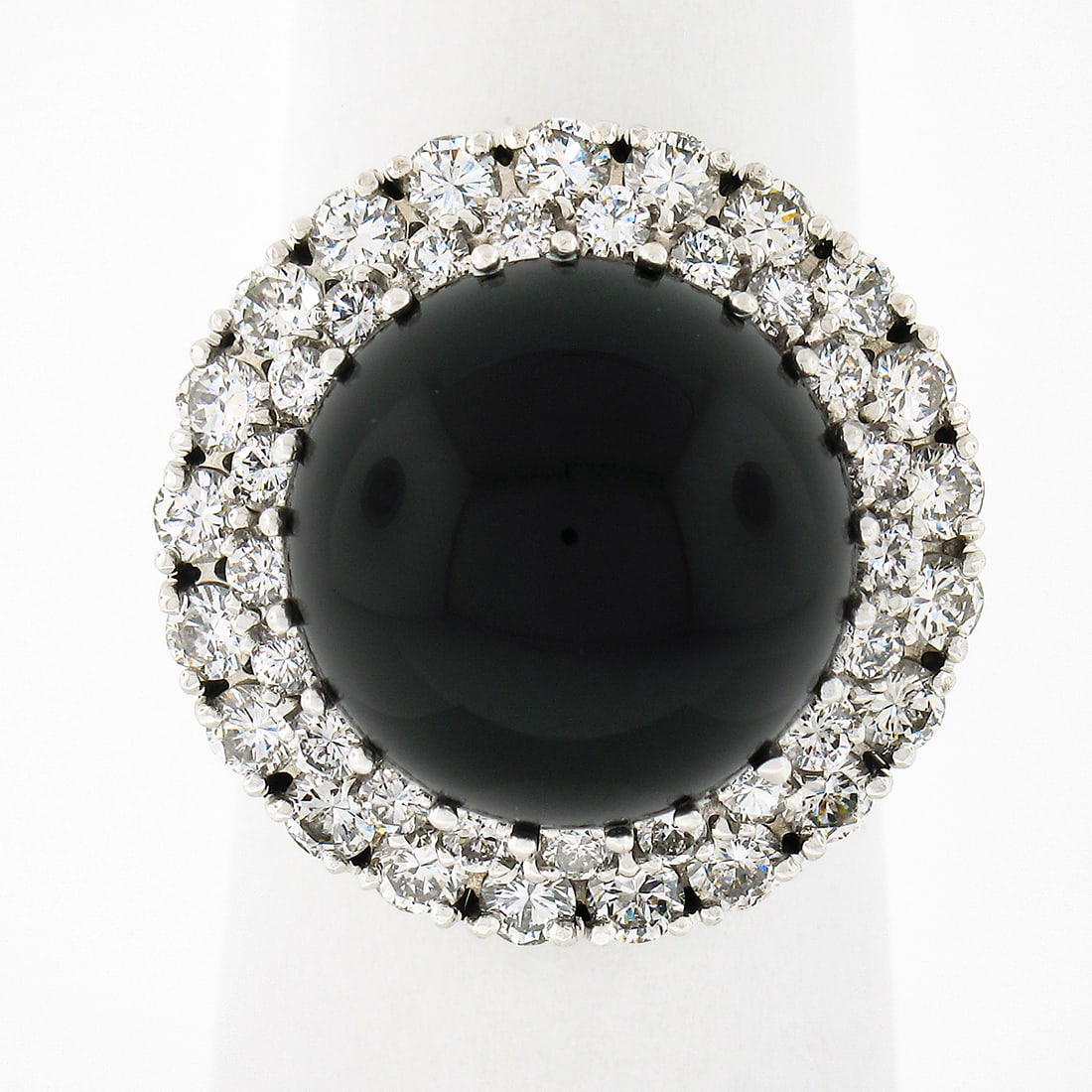 Vintage 18K White Gold Cocktail Ring with Black Onyx and Diamond Dual Halo: Vintage 18K White Gold Cocktail Ring with Black Onyx and Diamond Dual Halo Vintage cocktail ring crafted in solid 18k white gold, featuring a round cabochon natural black onyx center framed by a tiere