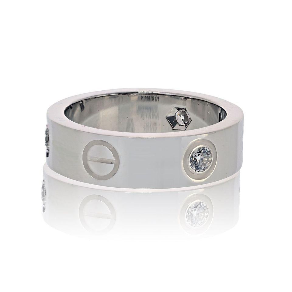 Love Collection 18K White Gold Ring with Three Diamonds by Cartier: Love Collection 18K White Gold Ring with Three Diamonds by Cartier This authentic Cartier Love ring is crafted from 18K white gold and features three brilliant-cut diamonds set flush within the iconic