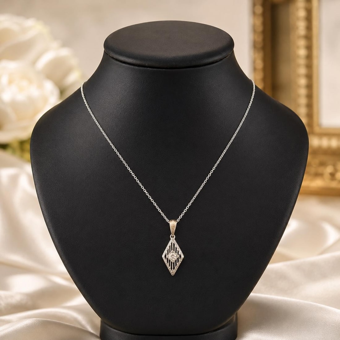 Art Deco 18k White Gold Diamond Filigree Pendant Necklace: Art Deco 18k White Gold Diamond Filigree Pendant Necklace Antique Art Deco necklace featuring a filigree lozenge pendant set with an old European cut natural diamond. Crafted in solid 18k white gold w