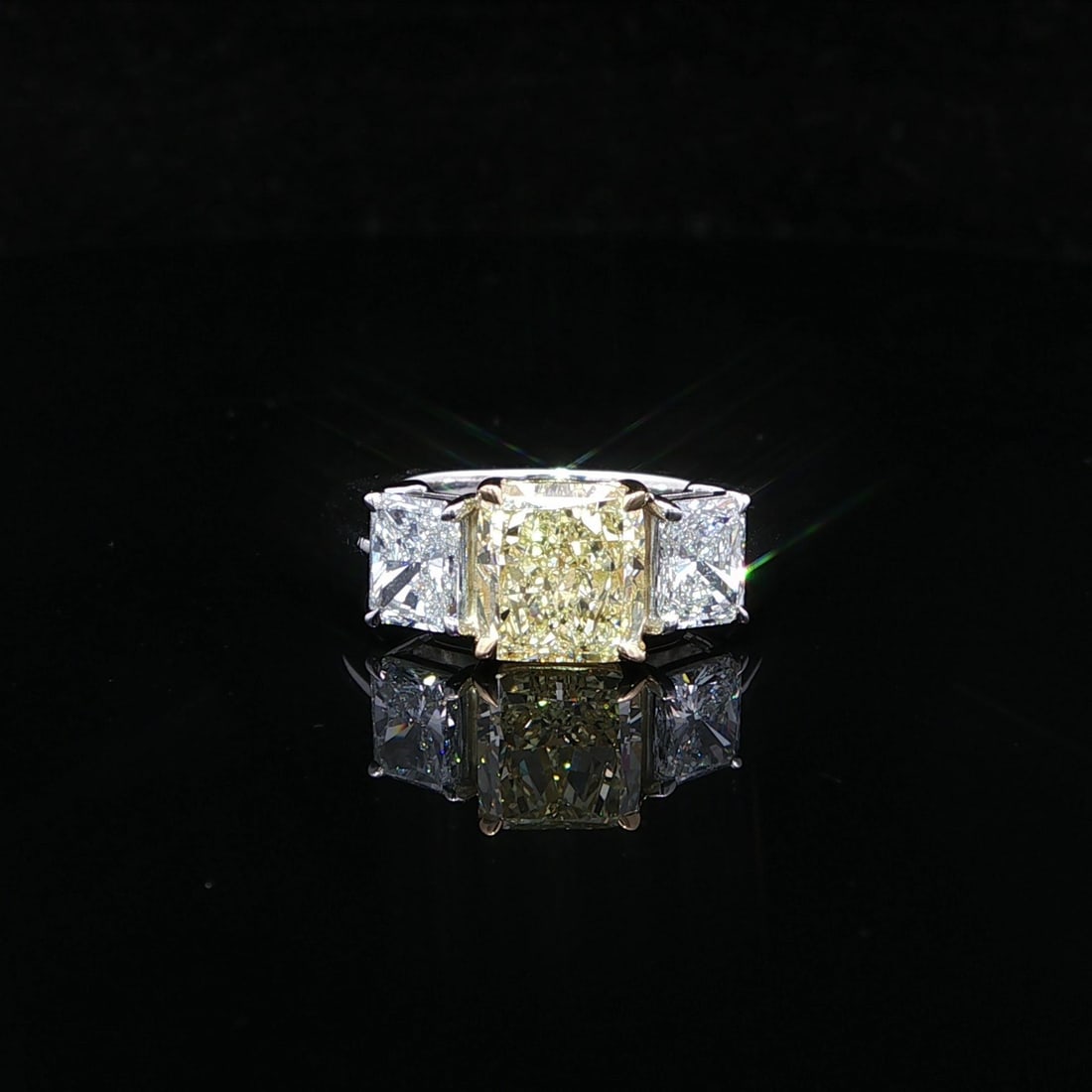 Platinum 18k Gold GIA 3.5ctw Radiant Diamond 3 Stone Ring: Platinum 18k Gold GIA 3.5ctw Radiant Diamond 3 Stone Ring Showcasing elegance and sophistication, this stunning cocktail ring features a captivating arrangement of three natural diamonds. The centerpi