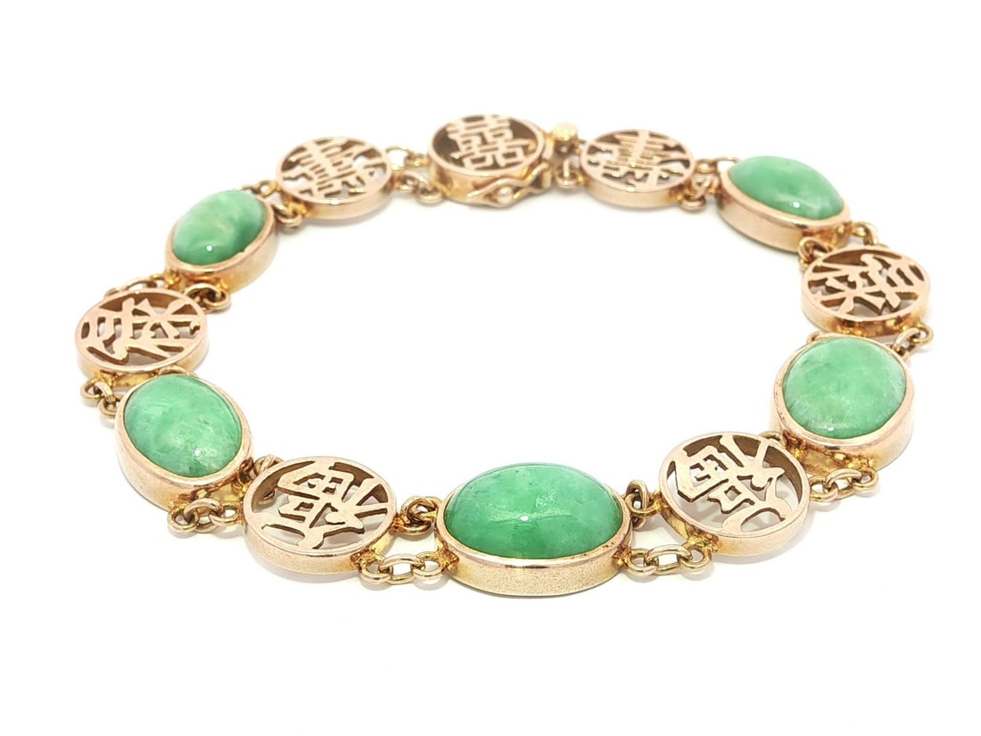 14k Yellow Gold Vintage Jade Cabochon Bracelet with Chinese Symbol Links: 14k Yellow Gold Vintage Jade Cabochon Bracelet with Chinese Symbol Links This vintage chain bracelet features five natural nephrite jade cabochons in an oval shape, each bezel set in solid 14k yellow 