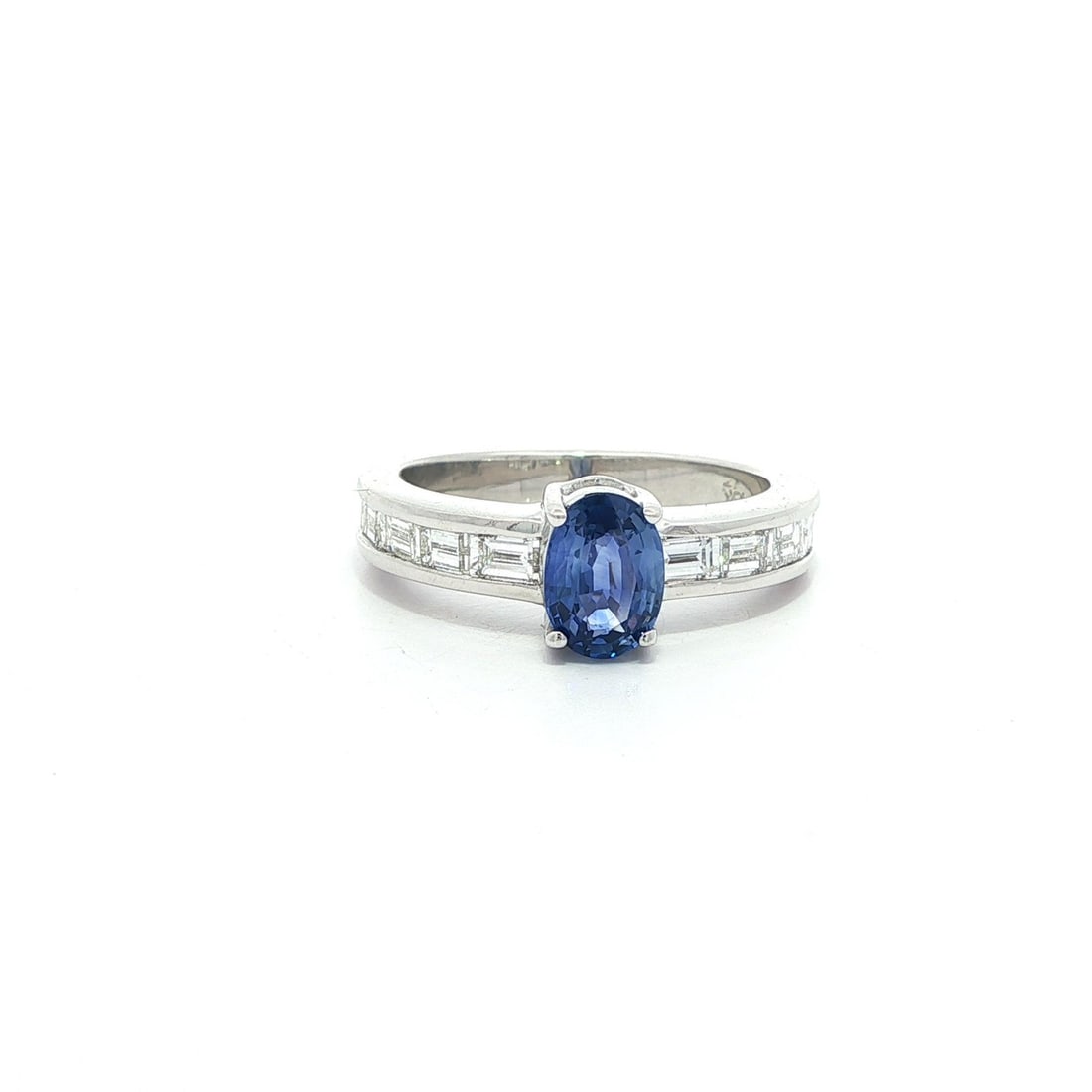 18k White Gold 1.80ct Oval Sapphire Baguette Diamond Cocktail Ring: 18k White Gold 1.80ct Oval Sapphire Baguette Diamond Cocktail Ring This exquisite cocktail ring showcases a stunning 1.80 carat total weight featuring a natural oval sapphire and baguette diamonds set