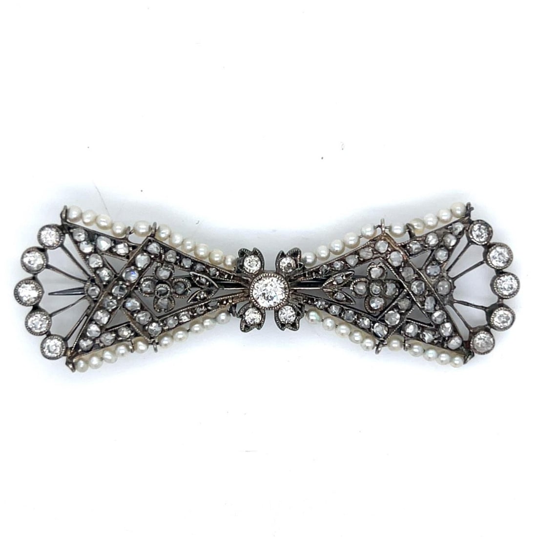 Platinum Art Deco Brooch with Natural Pearl and Diamond Accents: Platinum Art Deco Brooch with Natural Pearl and Diamond Accents This Art Deco brooch is crafted in platinum and features natural pearls accented by approximately 2.00 carats of rose-cut diamonds. It a