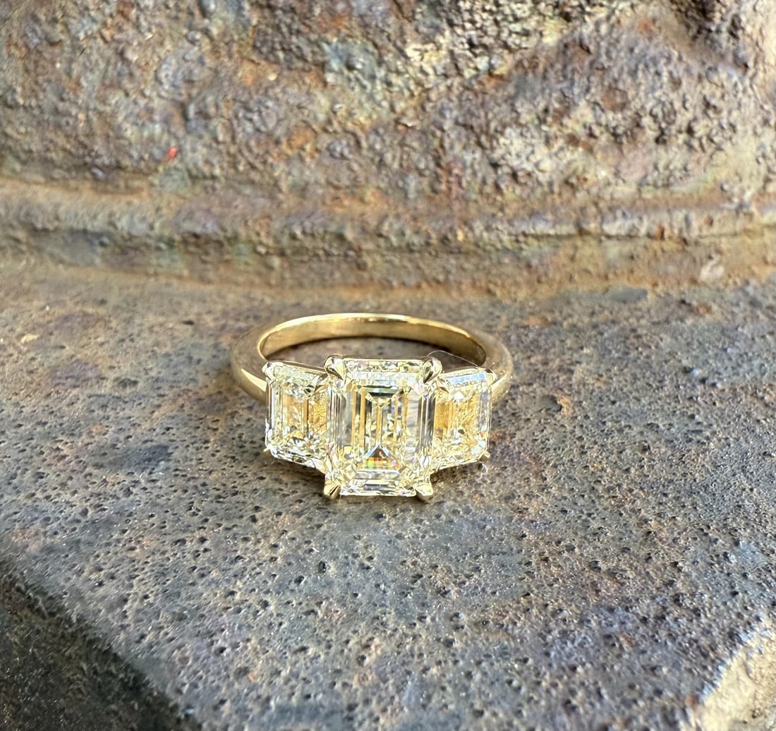 18k Yellow Gold GIA Certified Emerald Cut Diamond Cocktail Ring 3 Stone: 18k Yellow Gold GIA Certified Emerald Cut Diamond Cocktail Ring 3 Stone This un-used 18k yellow gold cocktail ring features three natural emerald cut diamonds with a total carat weight of 4.37ctw. The