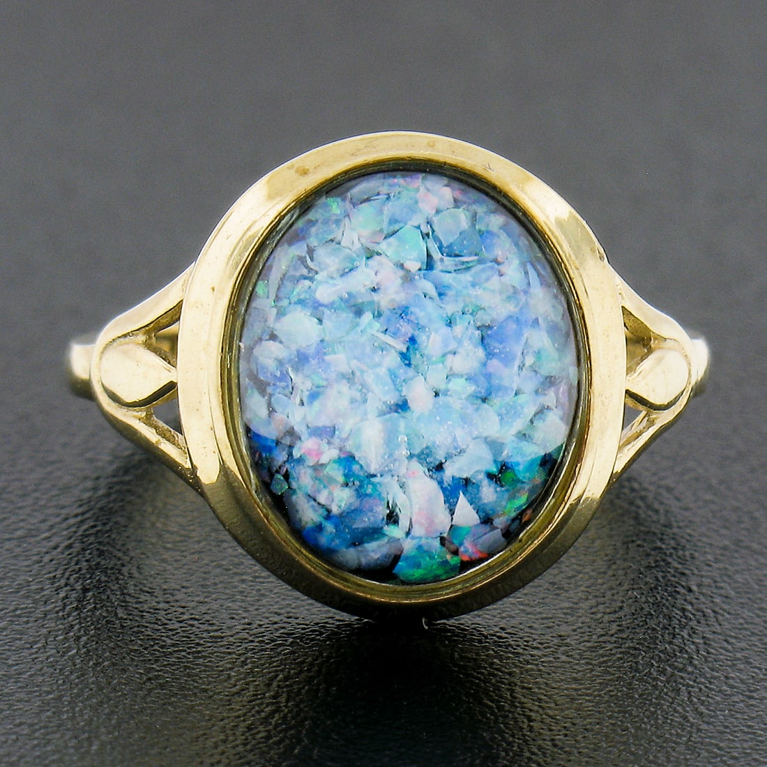 10K Yellow Gold Oval Triplet Opal Black Onyx Solitaire Ring: 10K Yellow Gold Oval Triplet Opal Black Onyx Solitaire Ring This stunning 10K Yellow Gold Bezel Oval Triplet Opal on Black Onyx Domed Solitaire Band Ring showcases a unique blend of vibrant colors and