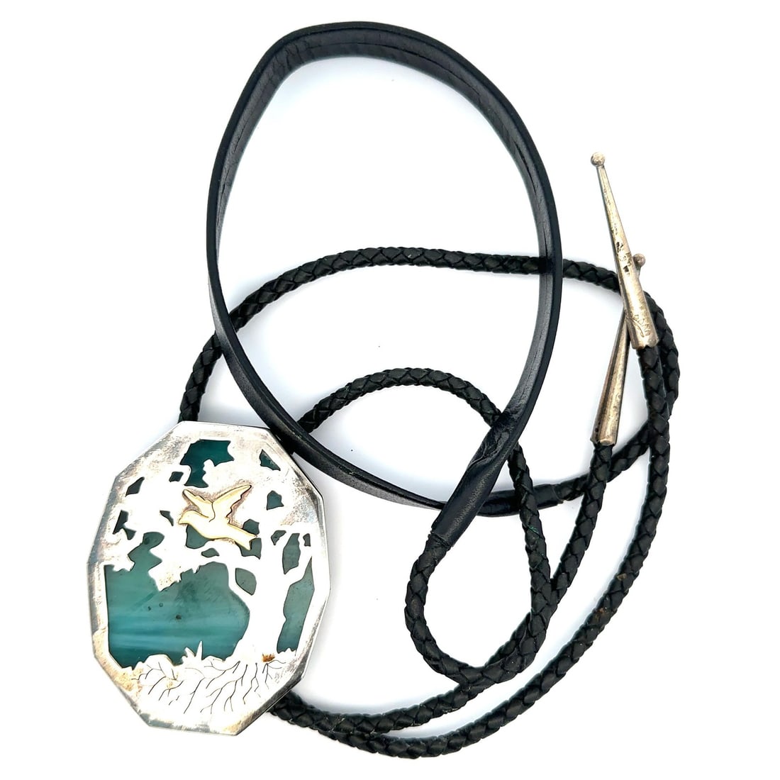 Sterling Silver Bolo Tie with Blue Stained Glass Nature Motif: Sterling Silver Bolo Tie with Blue Stained Glass Nature Motif This vintage bolo tie features a nature scene crafted from blue stained glass set in sterling silver. The bolo is complemented by a braide