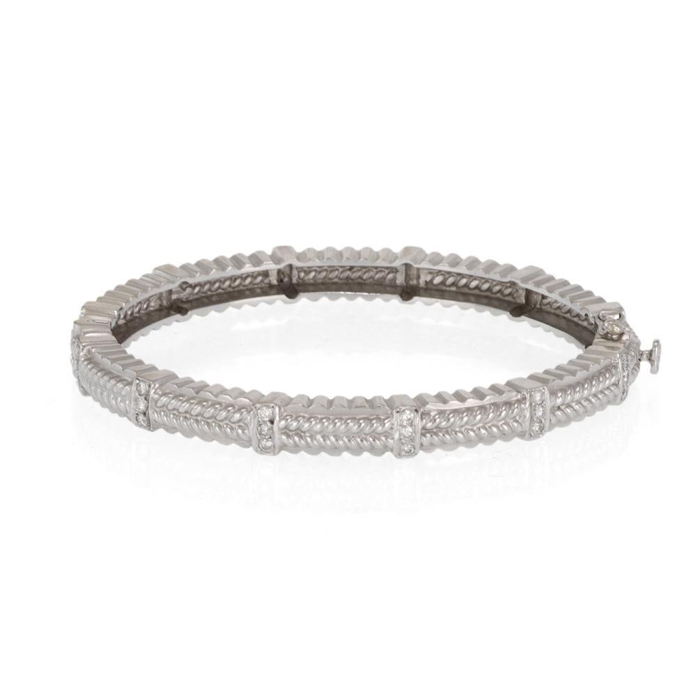 18k White Gold Diamond Leaf Design Bangle Bracelet: 18k White Gold Diamond Leaf Design Bangle Bracelet This exquisite bangle bracelet is crafted from 18k white gold and features a unique fancy leaf design. The oval-shaped bracelet has a secure hinge me