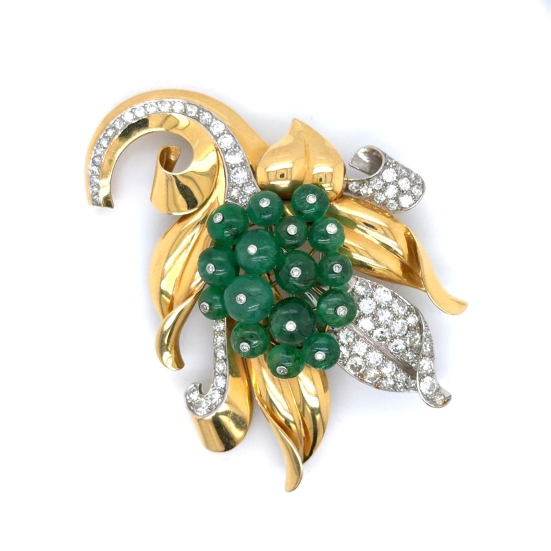 Emerald and Diamond Brooch in 18K Gold and Platinum by Trabert Hoeffer Mauboussin: Emerald and Diamond Brooch in 18K Gold and Platinum by Trabert Hoeffer Mauboussin This brooch by Trabert & Hoeffer & Mauboussin is crafted from 18K yellow gold and platinum. It features 16 emeralds wi