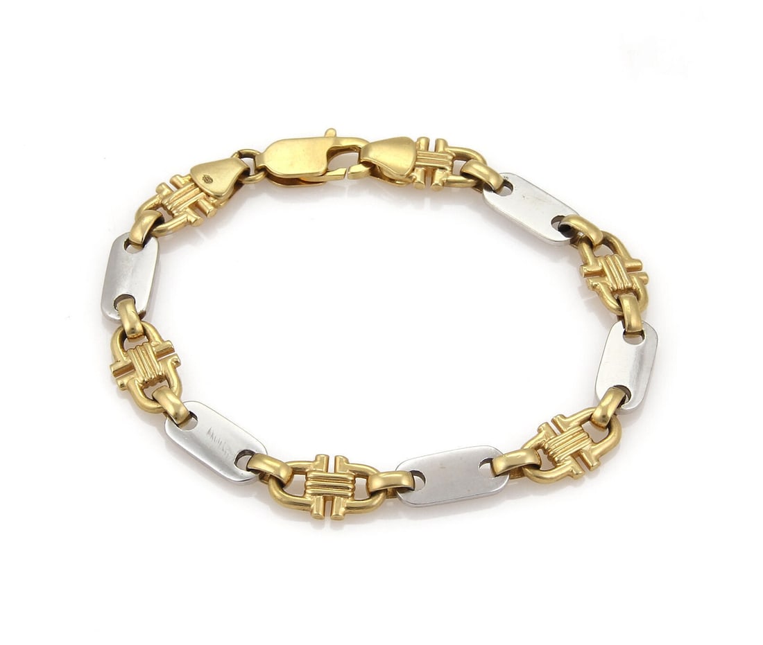 Vintage 18k Yellow and White Gold Bar Stirrup Link Bracelet: Vintage 18k Yellow and White Gold Bar Stirrup Link Bracelet This vintage estate bracelet features a bar and stirrup link motif in solid 18k yellow and white gold. It has a polished two-tone finish and