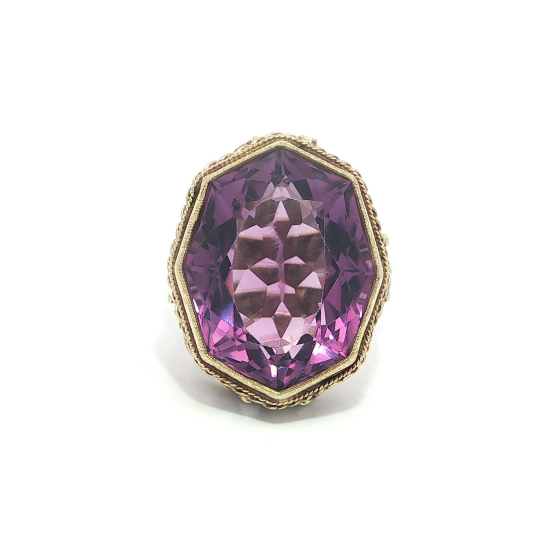 Arts and Crafts Era Yellow Gold Ring with Unique Amethyst and Leaf Motif: Arts and Crafts Era Yellow Gold Ring with Unique Amethyst and Leaf Motif This antique Arts & Crafts cocktail ring features a unique rectangular octagonal-cut natural amethyst in a bezel setting. Craft