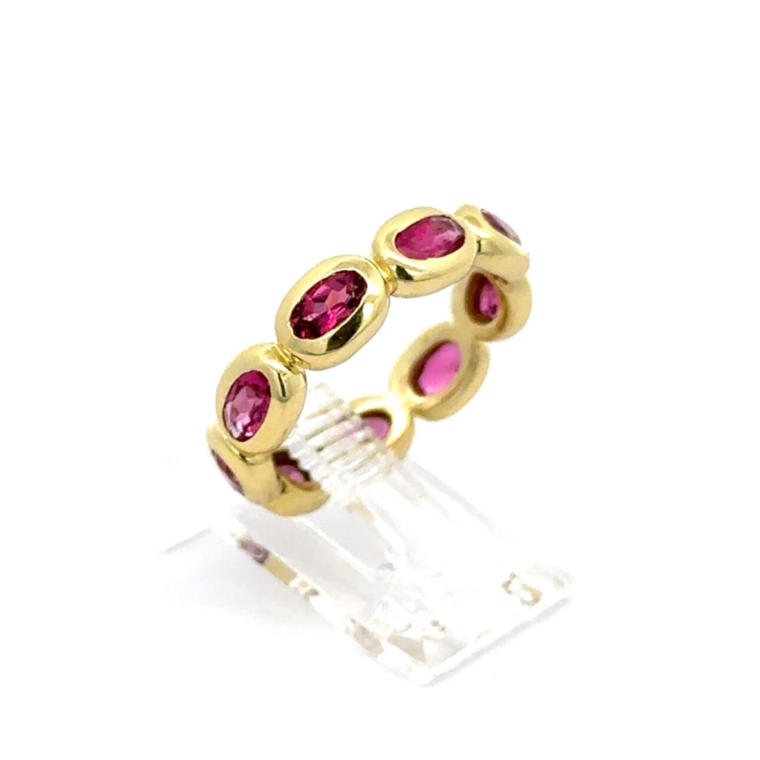 18k Yellow Gold 2.50ctw Pink Tourmaline Oval Eternity Band Ring: 18k Yellow Gold 2.50ctw Pink Tourmaline Oval Eternity Band Ring This elegant eternity band ring is crafted from solid 18k yellow gold and features a stunning array of natural pink tourmaline gemstones
