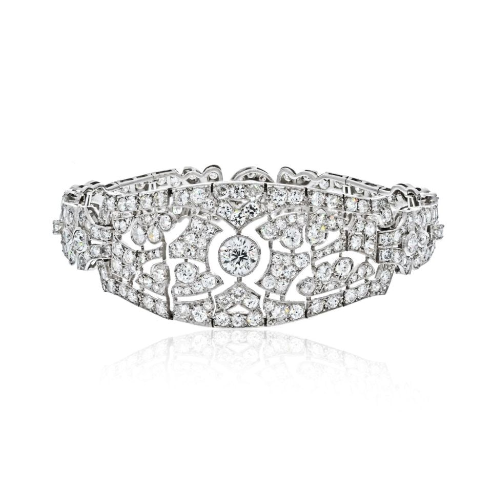 Art Deco Platinum Diamond Bracelet 12 Carats with Filigree Design: Art Deco Platinum Diamond Bracelet 12 Carats with Filigree Design This exquisite Art Deco bracelet showcases a stunning 12.00 carats of sparkling diamonds set in luxurious platinum. The centerpiece is