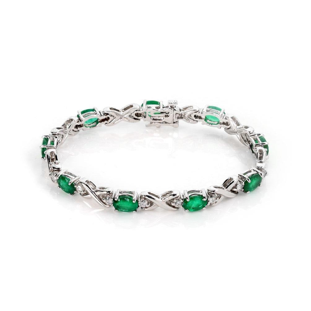 14k White Gold Emerald Diamond X Link Bracelet 9ct: 14k White Gold Emerald Diamond X Link Bracelet 9ct This exquisite bracelet is crafted from 14k white gold, showcasing a polished finish. The design features alternating oval links set with prong-set o