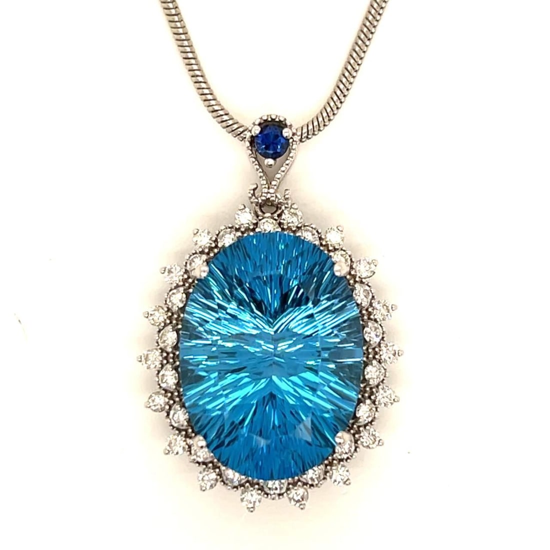 14K White Gold Blue Topaz 18.00 Ct Diamond Necklace: 14K White Gold Blue Topaz 18.00 Ct Diamond Necklace This stunning 14K white gold necklace showcases a captivating blue topaz and diamond design. The piece weighs 13.3 grams and features an approximate
