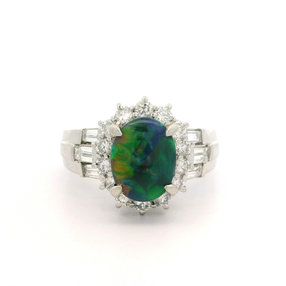 Platinum GIA Certified 2.27ctw Black Opal Diamond Cocktail Ring: Platinum GIA Certified 2.27ctw Black Opal Diamond Cocktail Ring This stunning cocktail ring showcases an exquisite natural black opal, expertly cut in an oval cabochon shape, measuring 8.99 x 7.01 x 3