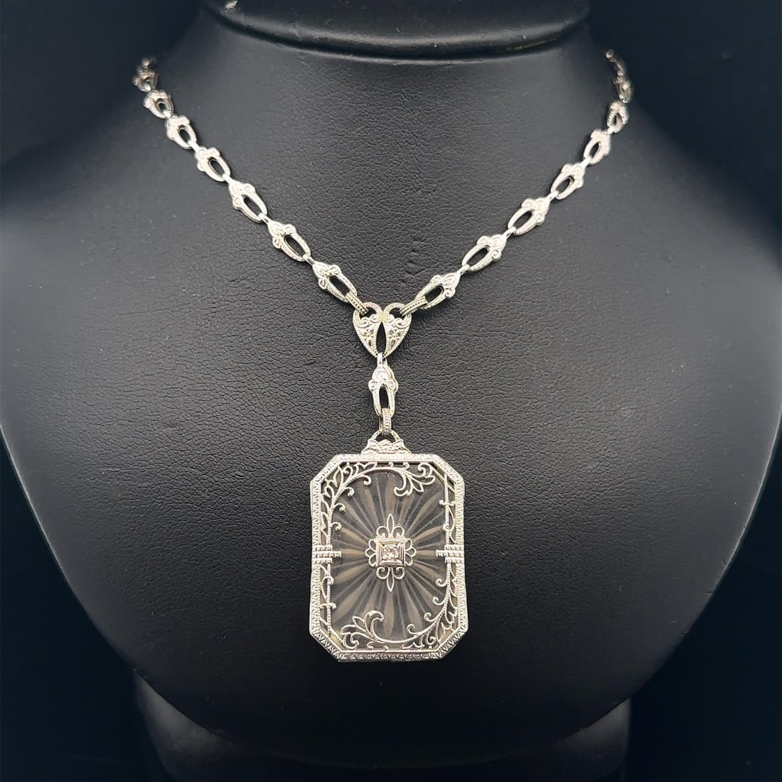 Art Deco Era 10k White Gold Camphor Glass Pendant Necklace with Diamond Accent 16.5": Art Deco Era 10k White Gold Camphor Glass Pendant Necklace with Diamond Accent 16.5" This antique Art Deco necklace features a camphor glass and diamond pendant set in solid white gold. The pendant sh