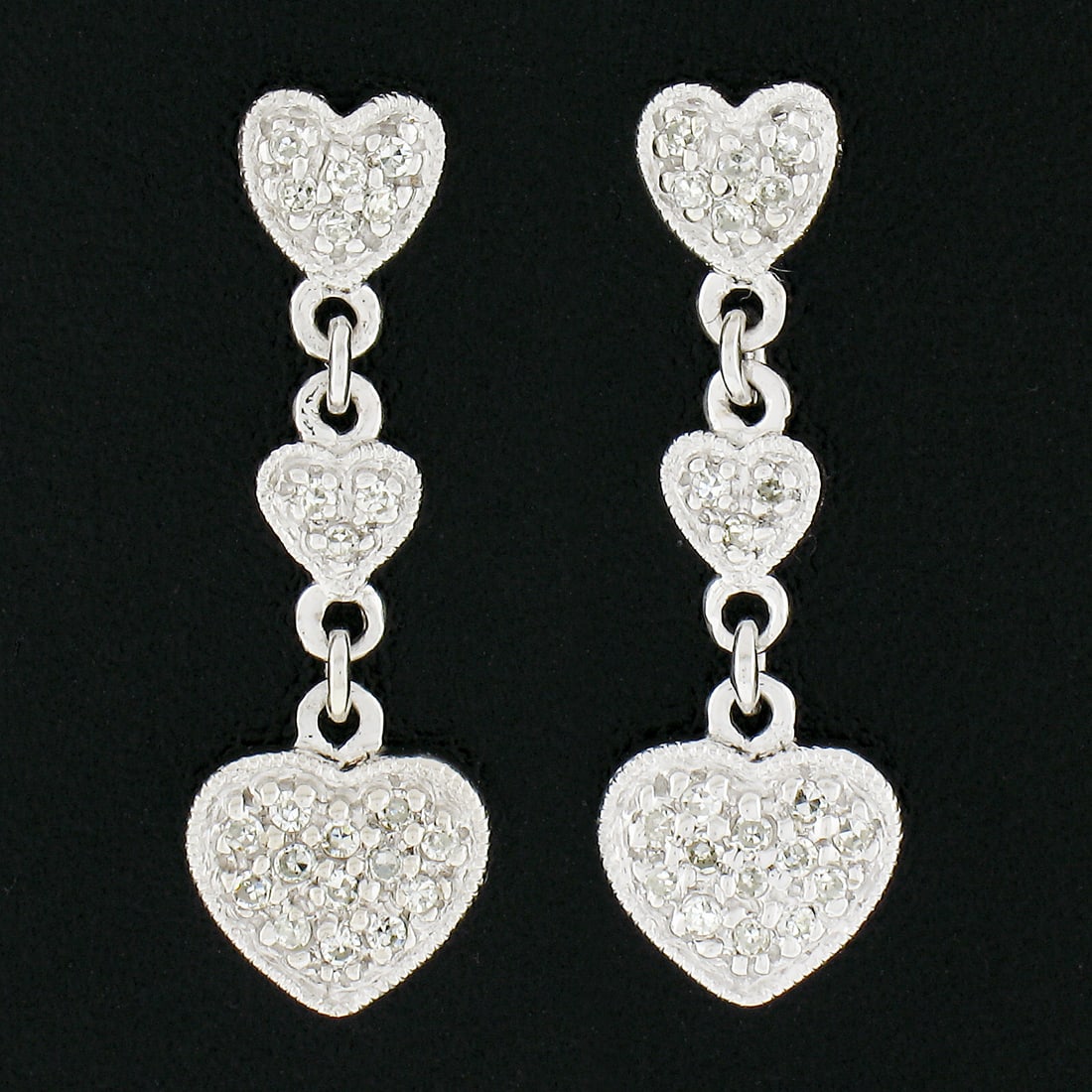 14K White Gold Triple Heart Diamond Drop Earrings 0.20ctw Milgrain Pave: 14K White Gold Triple Heart Diamond Drop Earrings 0.20ctw Milgrain Pave These elegant drop earrings are crafted from solid 14K white gold and feature a triple heart design, each heart accented with de