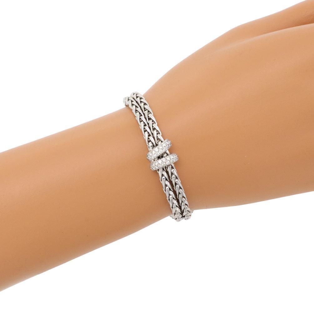 DAG Signed 18k White Gold Double Chain Diamond Bracelet: DAG Signed 18k White Gold Double Chain Diamond Bracelet This exquisite bracelet, signed DAG, is expertly crafted from 18k white gold and showcases a stunning double wheat link chain. It features three