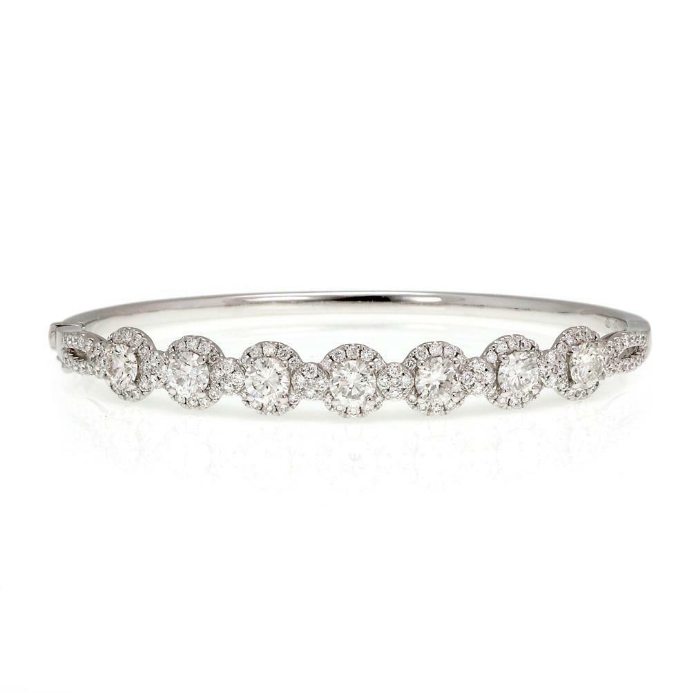 Elegant 3.18ct Diamond Halo Bangle in 18k White Gold: Elegant 3.18ct Diamond Halo Bangle in 18k White Gold This exquisite bangle bracelet features a modern design crafted from 18k white gold with a high polished finish. The front half is elegantly adorne