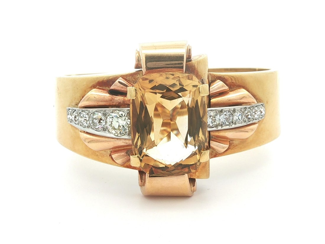 Retro citrine diamond hinged cuff in gold and platinum: Retro citrine diamond hinged cuff in gold and platinum This vintage retro hinged cuff bracelet features a striking cushion-cut natural citrine as its centerpiece, measuring approximately 22.2 x 16.2 m