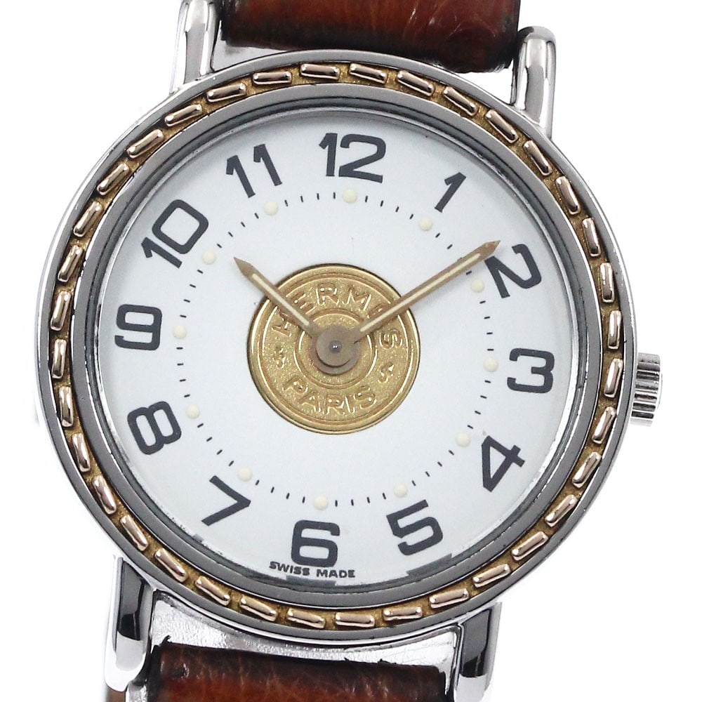 Hermes Serie Quartz Ladies Wristwatch Leather Band: Hermes Serie Quartz Ladies Wristwatch Leather Band This Hermes Sellier women's wristwatch features a stainless steel case paired with a white dial and a leather band. Powered by a quartz movement, thi