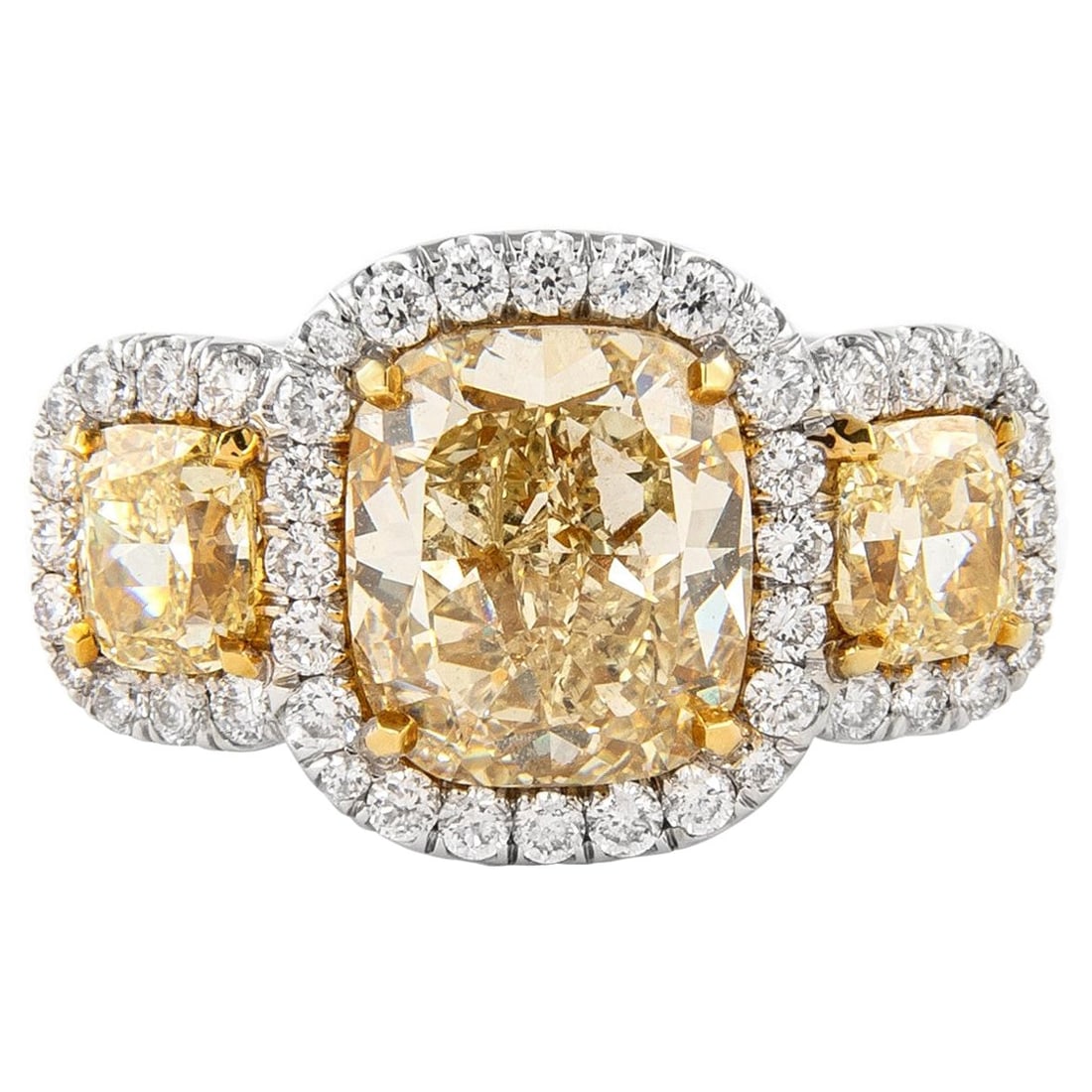 5.08ct Fancy Yellow Diamond Three-Stone Ring 18k Gold: 5.08ct Fancy Yellow Diamond Three-Stone Ring 18k Gold This exquisite three-stone ring showcases a stunning arrangement of natural fancy yellow diamonds, complemented by a halo of brilliant white diamo