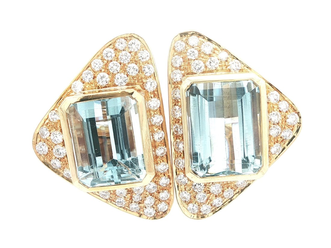 Emerald Cut Blue Topaz and Diamond Earrings in 18k Yellow Gold Statement Design: Emerald Cut Blue Topaz and Diamond Earrings in 18k Yellow Gold Statement Design These vintage statement earrings feature two natural blue topaz stones in emerald cut, bezel set in solid 18k yellow gol