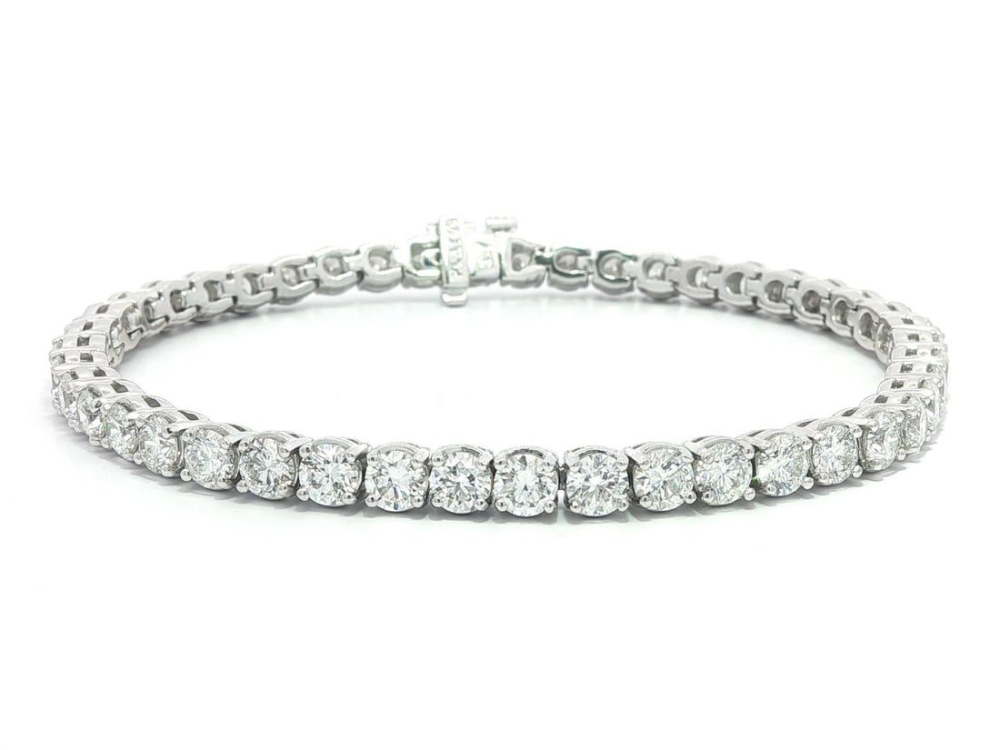Platinum Tennis Bracelet with 8.80ctw F VS2 Round Brilliant Diamonds 6.75 Inch: Platinum Tennis Bracelet with 8.80ctw F VS2 Round Brilliant Diamonds 6.75 Inch This un-used platinum tennis bracelet features 40 natural round brilliant cut diamonds, totaling 8.80 carats. Each diamon