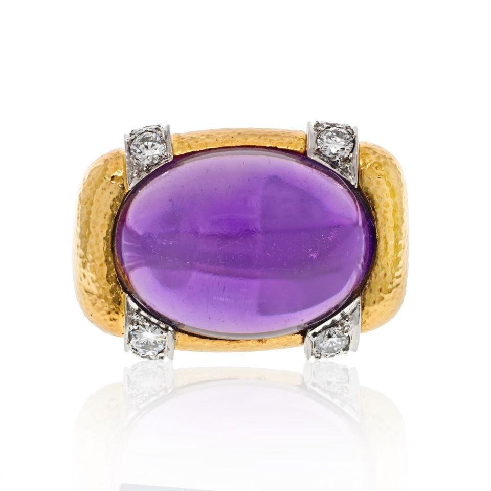 David Webb Platinum 18K Yellow Gold Amethyst Diamond Cocktail Ring: David Webb Platinum 18K Yellow Gold Amethyst Diamond Cocktail Ring This exquisite cocktail ring features a stunning cabochon amethyst set in a unique East to West orientation, surrounded by sparkling 