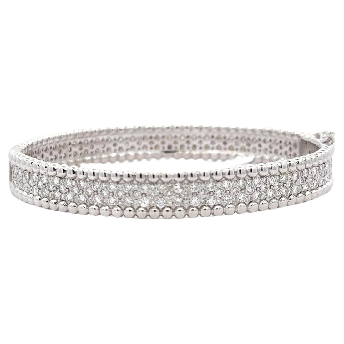 Contemporary 14K White Gold Diamond Bangle 3.88 Carats F-G VS1-VS2: Contemporary 14K White Gold Diamond Bangle 3.88 Carats F-G VS1-VS2 This exquisite bangle bracelet is crafted from 14 karat white gold, showcasing a contemporary design. It features three rows of 286 r