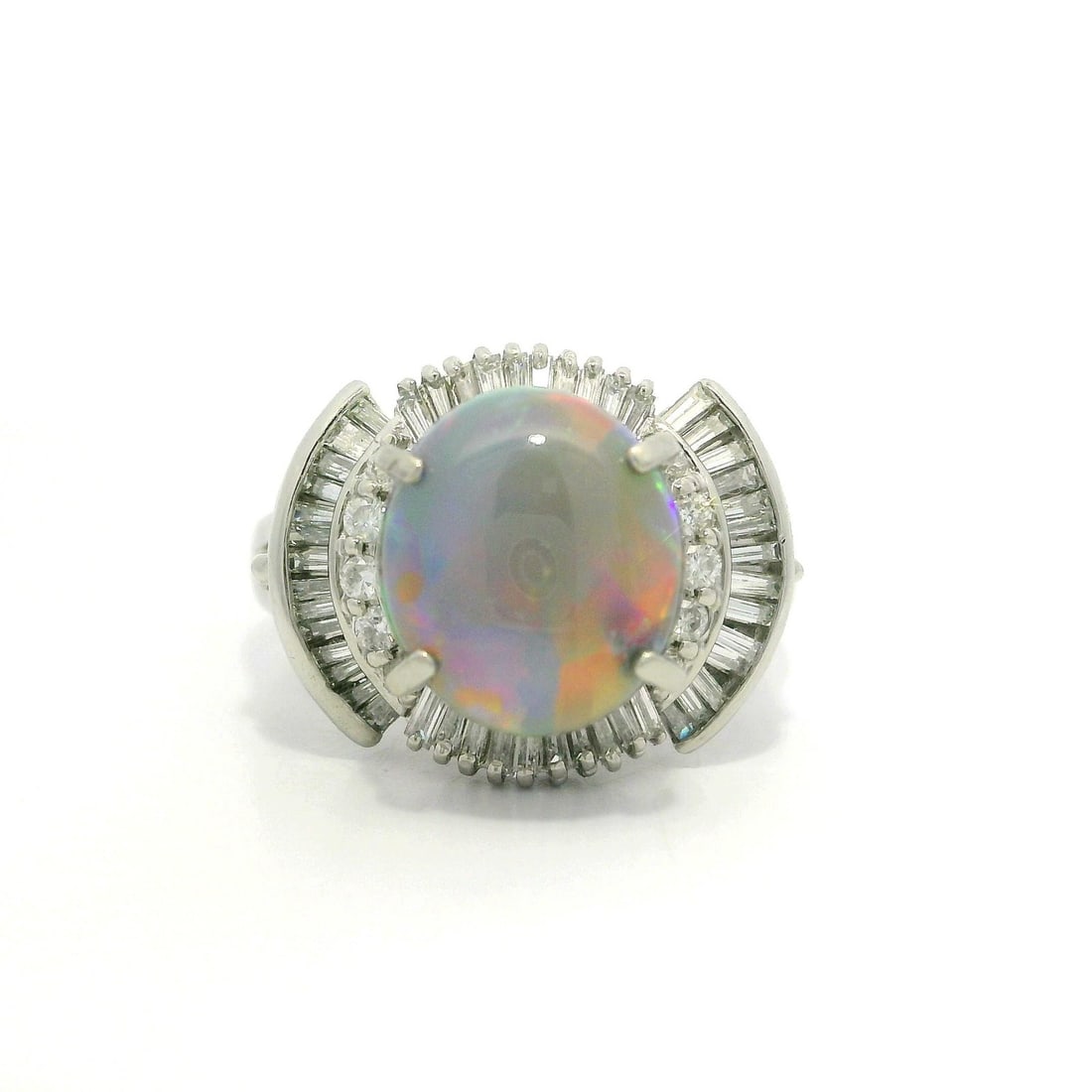Platinum 2.85ctw Opal and Diamond Cocktail Ring: Platinum 2.85ctw Opal and Diamond Cocktail Ring Make a bold statement with this stunning cocktail ring featuring a captivating natural opal. The centerpiece is a 2.25ct oval cabochon opal, displaying 