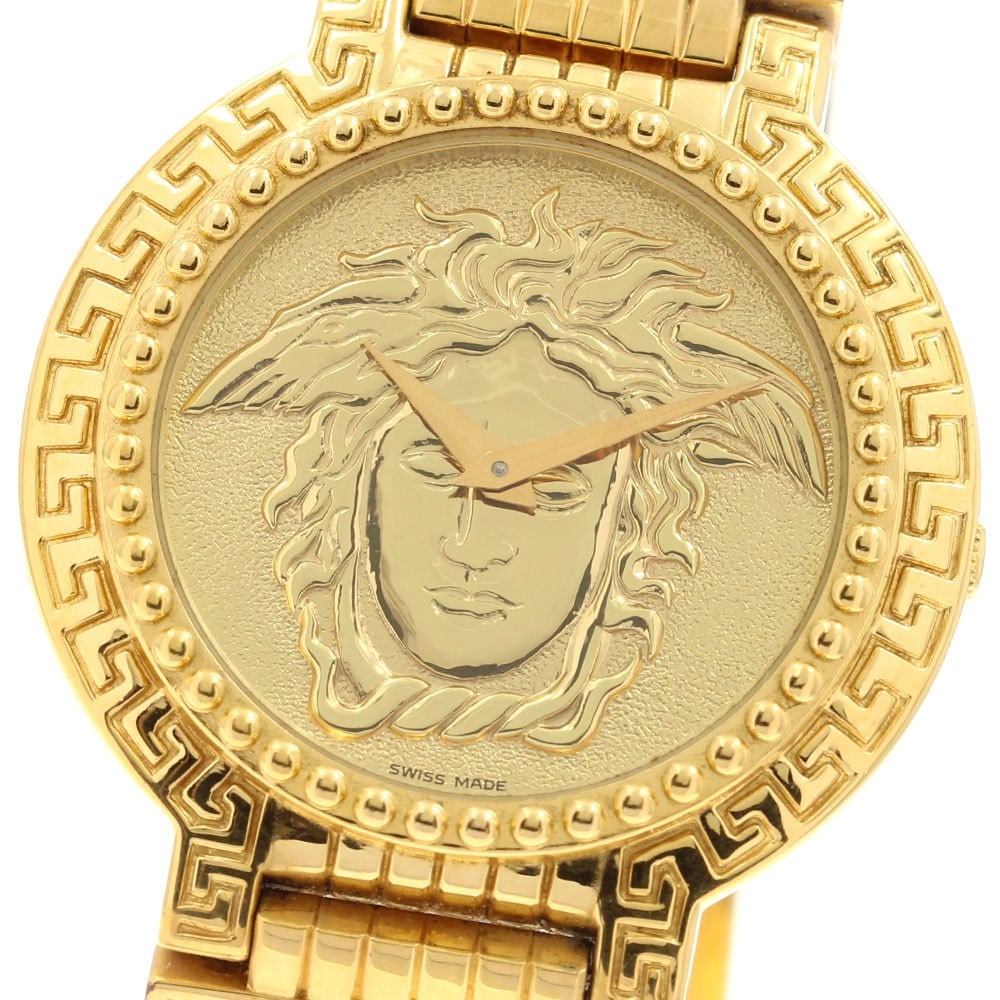 Versace Medusa Coin quartz men's wristwatch 7008011: Versace Medusa Coin quartz men's wristwatch 7008011 This pre-owned Versace Medusa Coin Watch, model 7008011, features a gold-tone dial and a stainless steel case with gold plating. The watch is powere