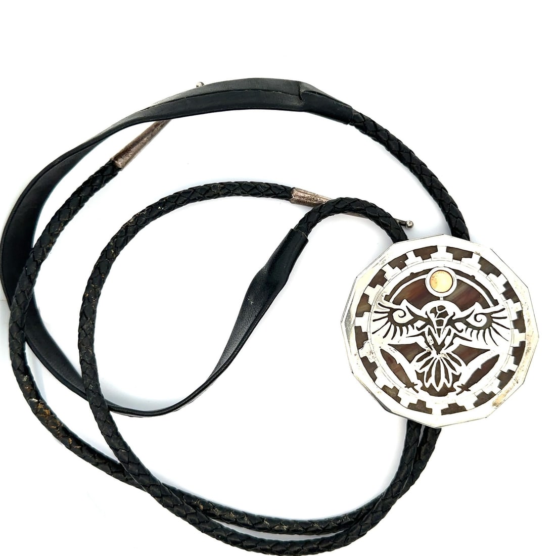 Sterling Silver Eagle and Feather Stained Glass Bolo Tie with Leather Cord: Sterling Silver Eagle and Feather Stained Glass Bolo Tie with Leather Cord This bolo tie features a detailed eagle and feather motif crafted in sterling silver, set over vibrant stained glass. The pie