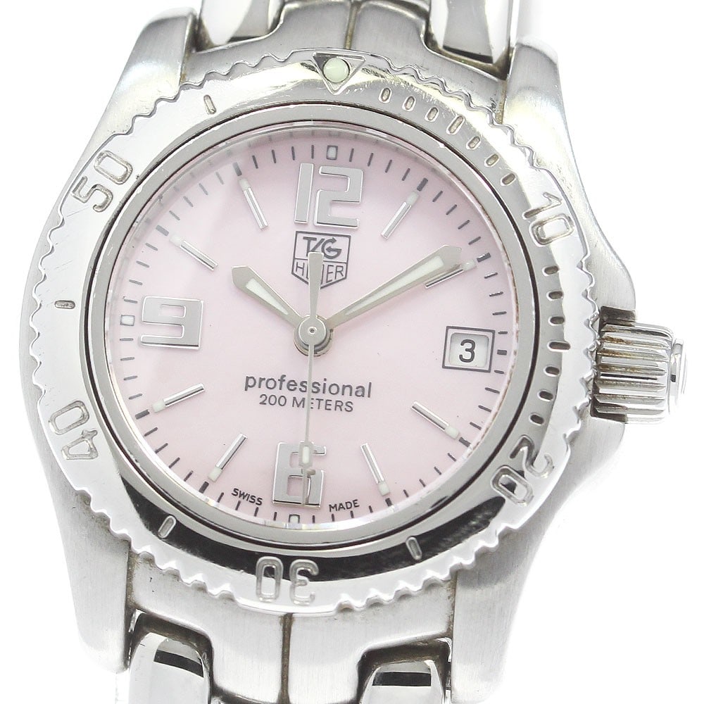 TAG Heuer Link WT141F Pink Shell Quartz Ladies Watch: TAG Heuer Link WT141F Pink Shell Quartz Ladies Watch This TAG HEUER Link Date Quartz women's wristwatch features a stainless steel case and bracelet, complemented by a pink shell dial. The watch is po