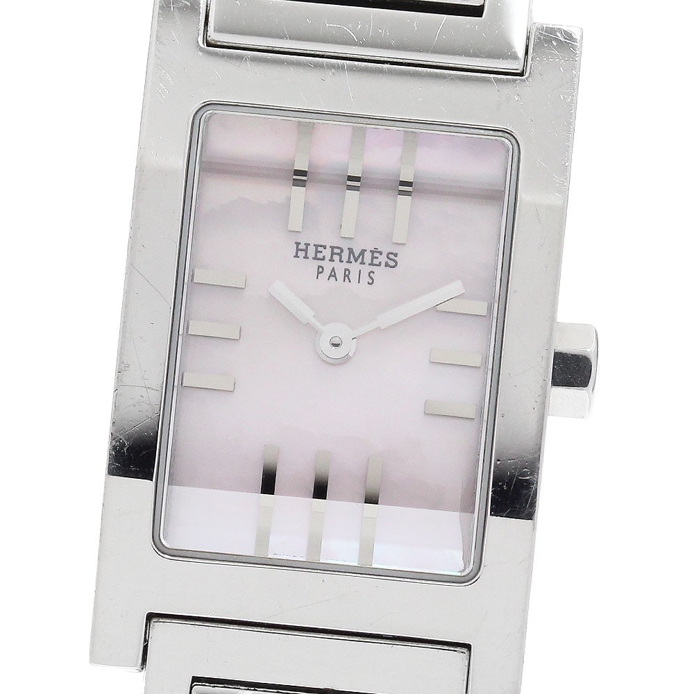 Hermes Tandem Quartz Shell Dial Womens Stainless Steel Watch TA1.210: Hermes Tandem Quartz Shell Dial Womens Stainless Steel Watch TA1.210 This Hermes Tandem TA1.210 women's wristwatch features a shell dial and is powered by a quartz movement. The case and bracelet are 