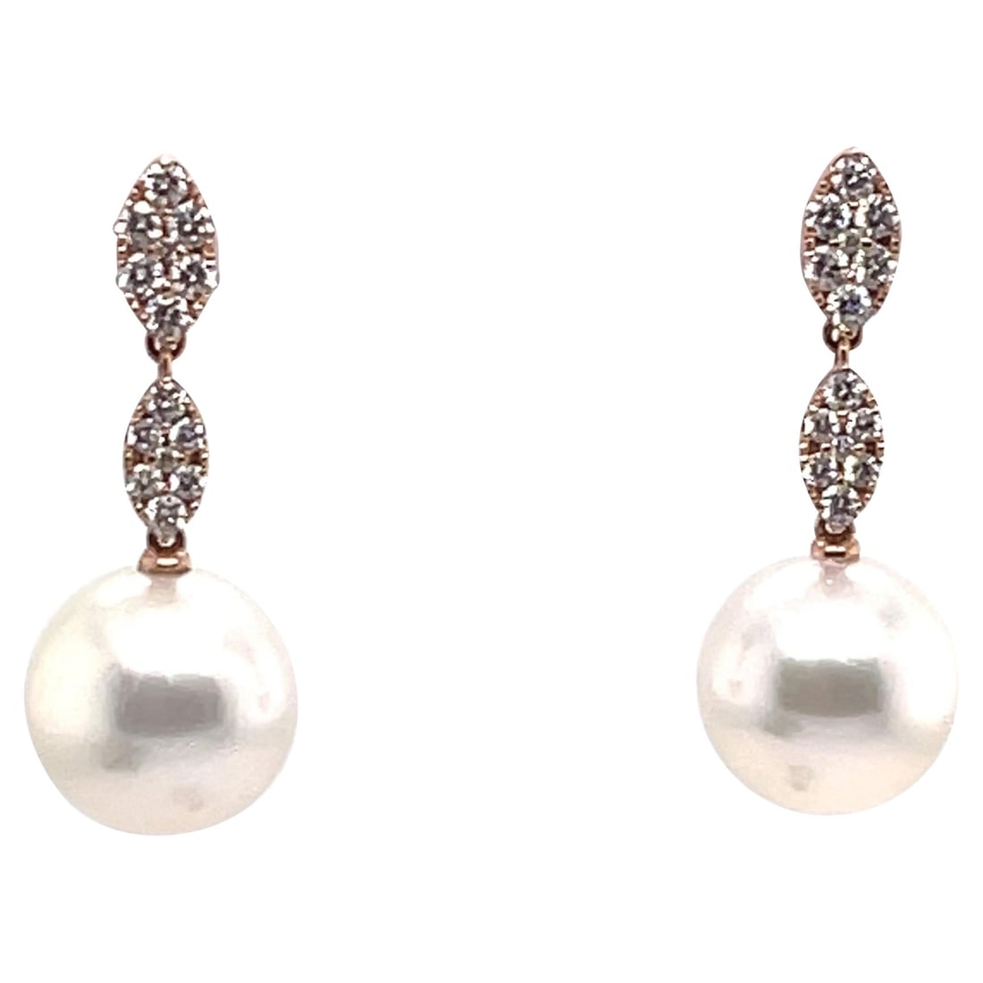 18K Rose Gold Diamond Drop Earrings with South Sea Pearls: 18K Rose Gold Diamond Drop Earrings with South Sea Pearls This exquisite pair of drop earrings features stunning South Sea pearls, each measuring 11-12mm, elegantly complemented by sparkling round cut