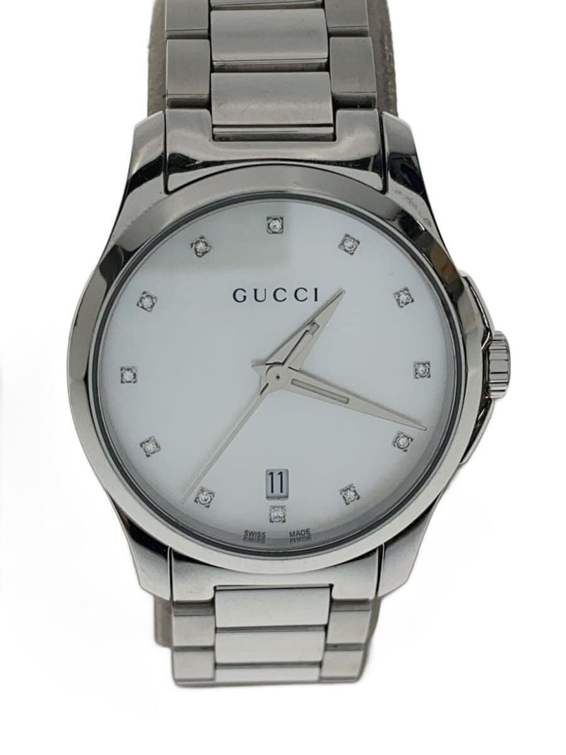 Gucci G-Timeless Silver Quartz Ladies Wristwatch: Gucci G-Timeless Silver Quartz Ladies Wristwatch This GUCCI G-Timeless Quartz women's wristwatch features a silver-tone case and band, crafted in Switzerland. The watch is slightly used and graded as 