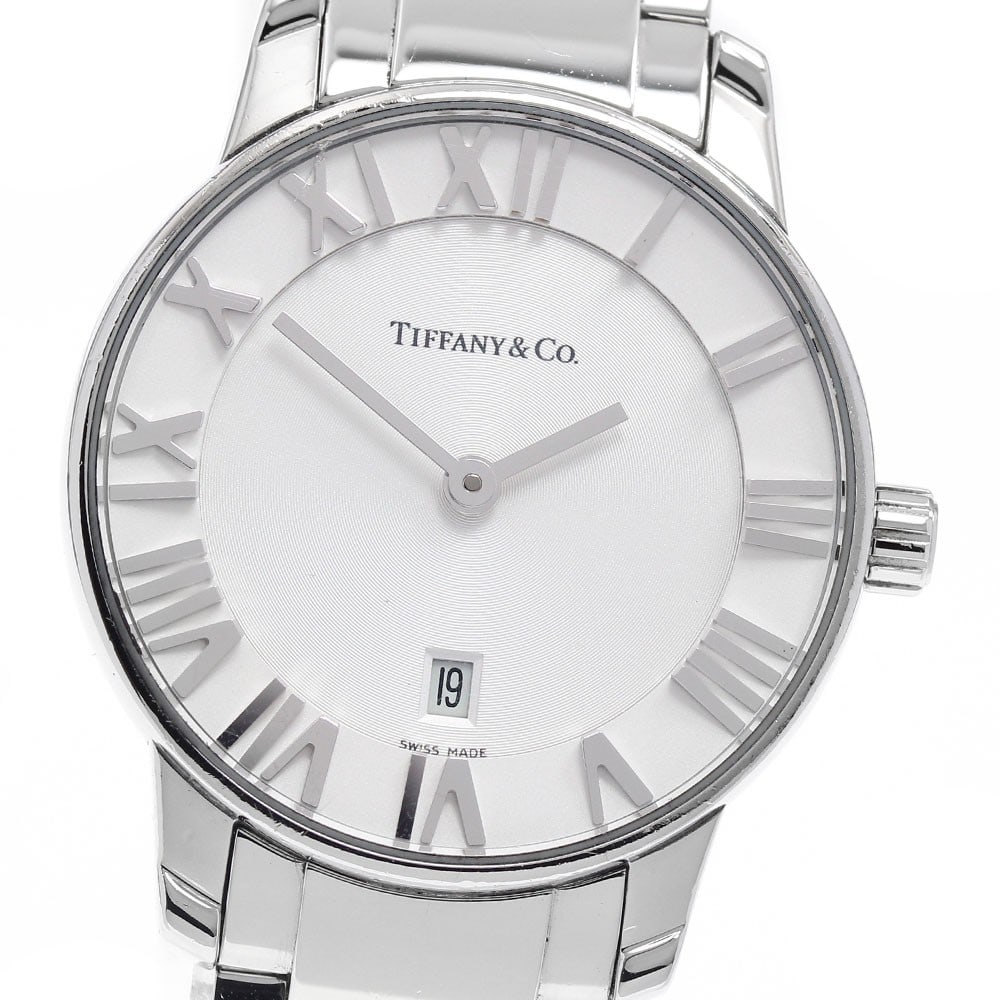 Tiffany Atlas Dome quartz date stainless steel women's wristwatch: Tiffany Atlas Dome quartz date stainless steel women's wristwatch This Tiffany & Co. Atlas Dome women's wristwatch features a stainless steel case and bracelet with a silver dial. The watch is powered