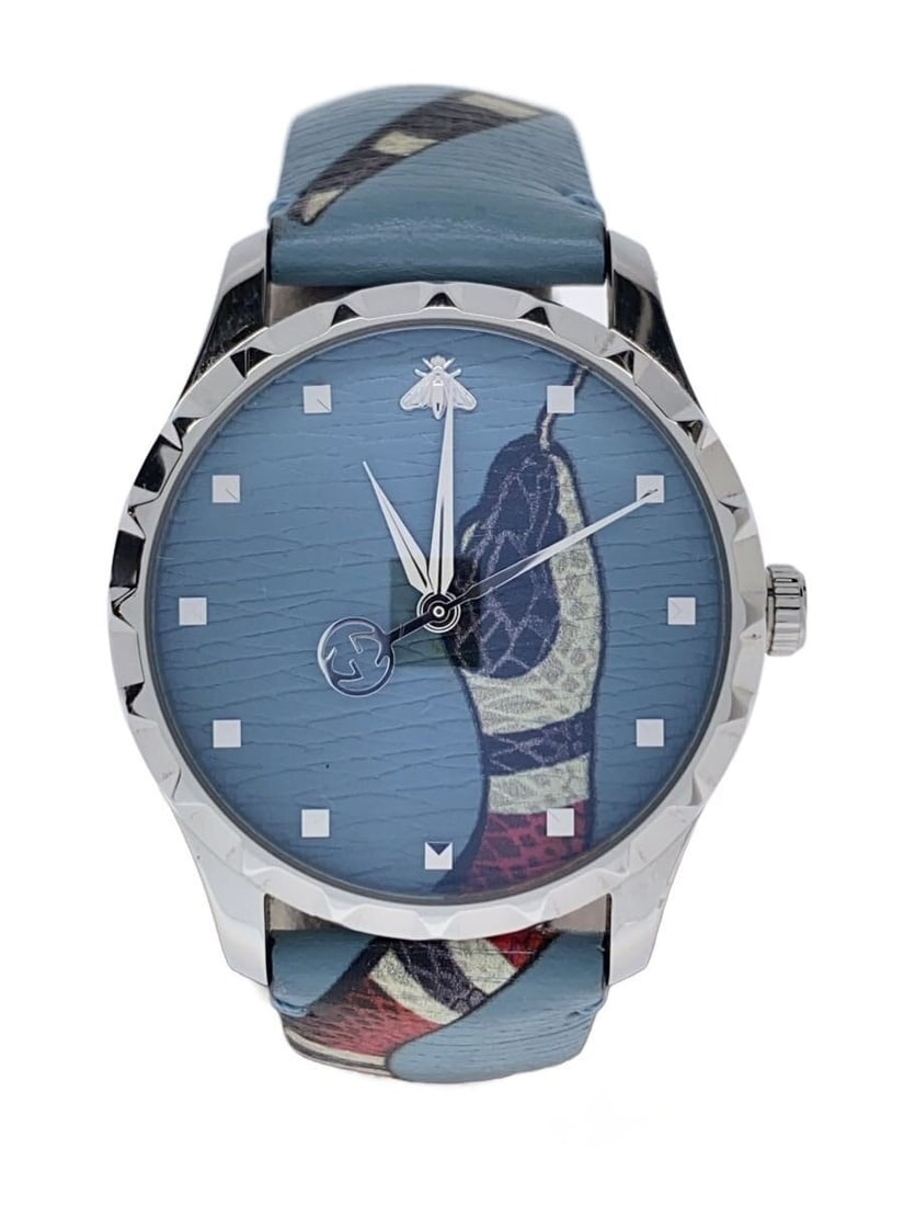 Gucci G Timeless blue leather quartz wristwatch YA1264080: Gucci G Timeless blue leather quartz wristwatch YA1264080 This GUCCI G-TIMELESS Quartz YA1264080 men's wristwatch features a blue dial and a leather band. The watch is Swiss-made and designed for men.
