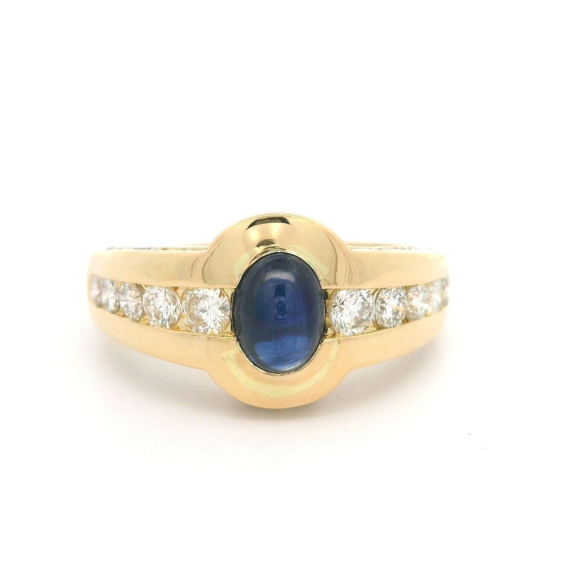 18k Yellow Gold Cocktail Ring with Blue Cabochon Sapphire and Diamonds: 18k Yellow Gold Cocktail Ring with Blue Cabochon Sapphire and Diamonds This exquisite cocktail ring showcases a stunning natural cabochon sapphire at its center, elegantly bezel set to highlight its r