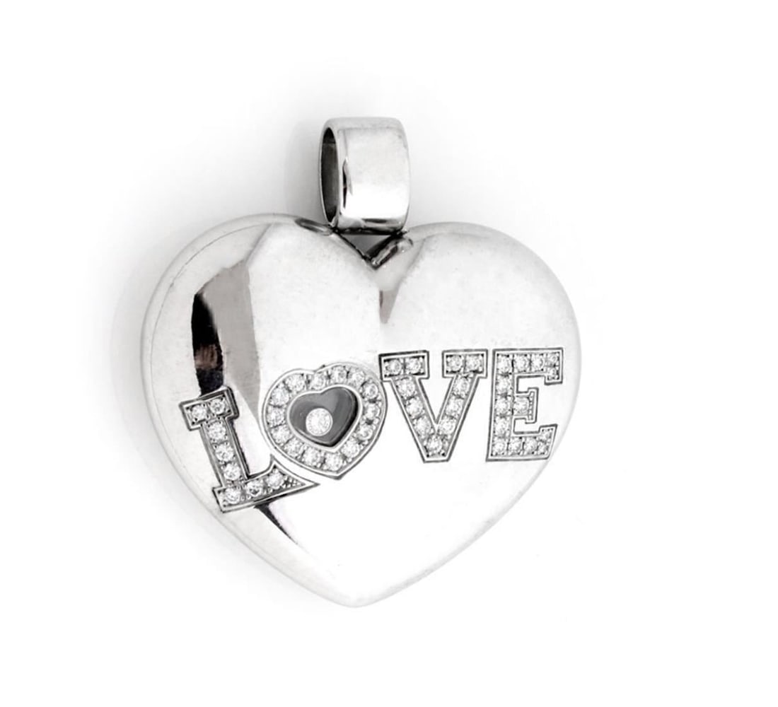 Chopard Happy Diamonds 18k White Gold Large Heart LOVE Pendant: Chopard Happy Diamonds 18k White Gold Large Heart LOVE Pendant A bold Chopard Happy Diamonds pendant in a large puffed heart design with the word LOVE and a heart-shaped chamber holding Chopard's sign