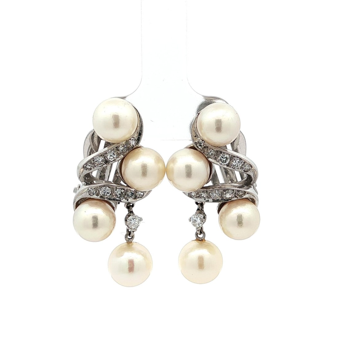 Vintage White Gold Pearl and Diamond Drop Earrings 0.60ctw: Vintage White Gold Pearl and Diamond Drop Earrings 0.60ctw Elevate your collection with these exquisite Vintage White Gold Drop Dangle Earrings, featuring an elegant swirl design. Each earring showcas