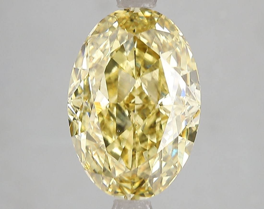 Loose Diamond - OVAL 5.08ct Fancy Vivid Yellow VS2: Loose Diamond - OVAL 5.08ct Fancy Vivid Yellow VS2 Source: This is a real non-mined Diamond that has been grown in a lab Shape: OVAL Carats: 5.08 Color: Fancy Vivid Yellow Certification: IGI Video:
