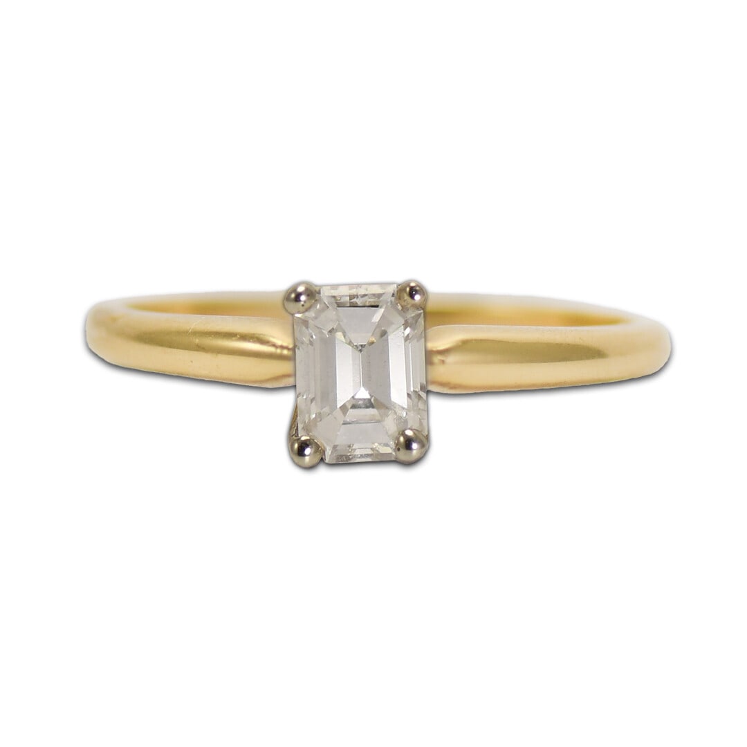 Emerald Cut Diamond Solitaire Ring in 14K Yellow Gold 0.45ct Size 6: Emerald Cut Diamond Solitaire Ring in 14K Yellow Gold 0.45ct Size 6 Pre-owned diamond solitaire ring in 14k yellow gold featuring one natural emerald-cut diamond in a prong setting. The diamond is des