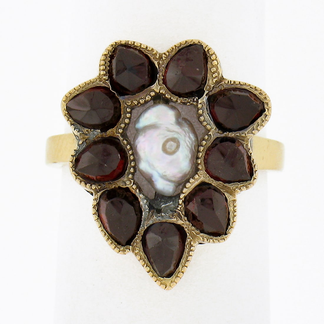 Antique 14k Yellow Gold Garnet Teardrop Halo Ring with Baroque Pearl: Antique 14k Yellow Gold Garnet Teardrop Halo Ring with Baroque Pearl This exquisite antique ring is crafted from solid 14k yellow gold, showcasing a stunning baroque pearl at its center. The pearl is 