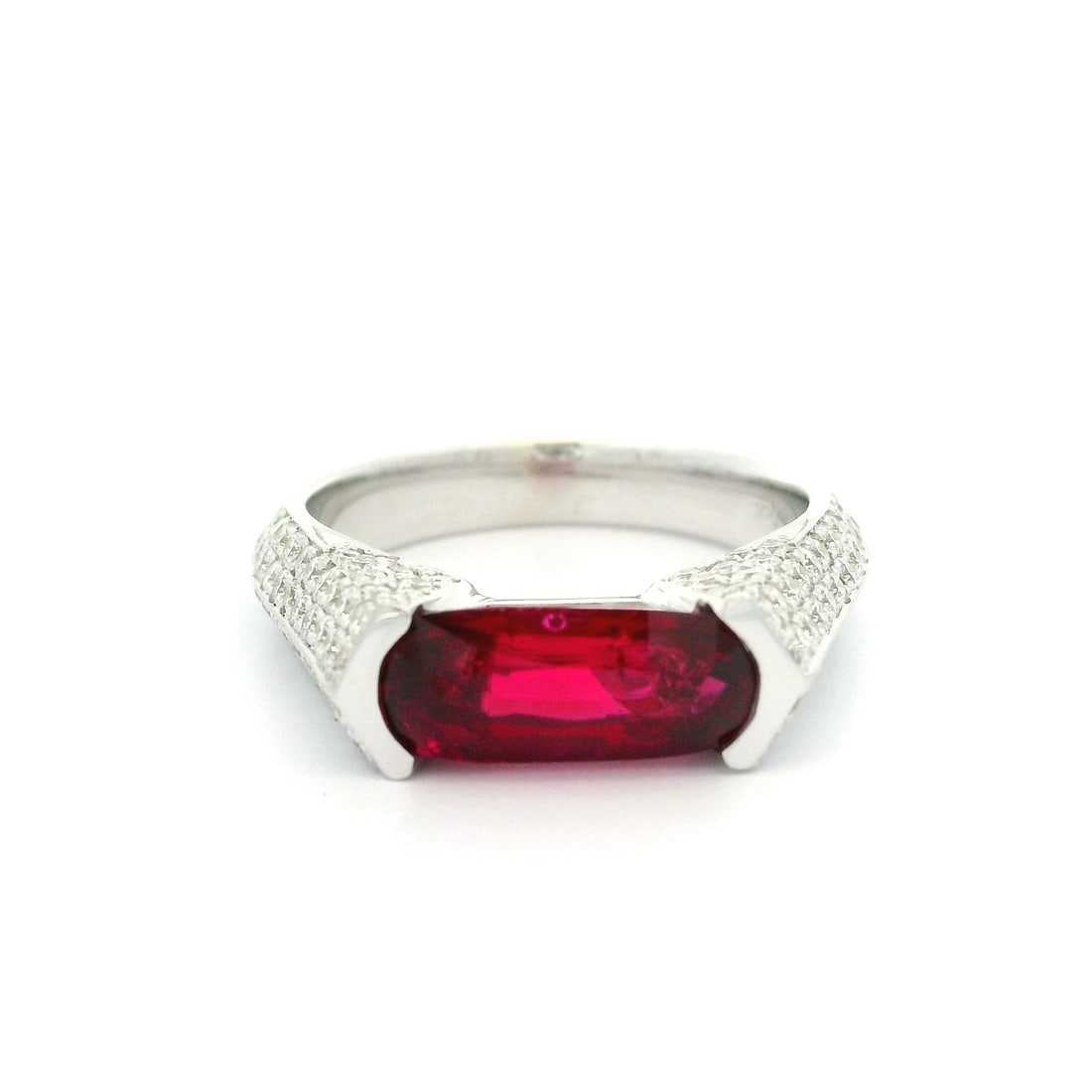 18k White Gold GIA 2.04ctw No Heat Ruby Diamond Band Ring: 18k White Gold GIA 2.04ctw No Heat Ruby Diamond Band Ring This stunning statement band ring showcases a natural, genuine elongated oval cut ruby, channel set in solid 18k white gold. The vivid red rub