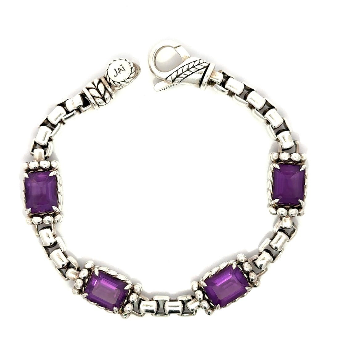 Sterling Silver Amethyst Station Bracelet 8ctw Emerald Cut Lobster Clasp: Sterling Silver Amethyst Station Bracelet 8ctw Emerald Cut Lobster Clasp Sterling silver station bracelet featuring four natural amethysts in an emerald cut and prong setting. The bracelet has a box l